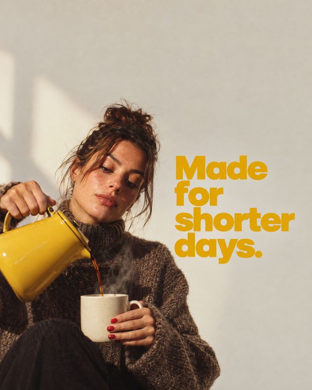 kettle autumn product photo: A woman in a chunky brown sweater pours from a bright yellow kettle into a mug in warm natural light, beside bold golden lettering…