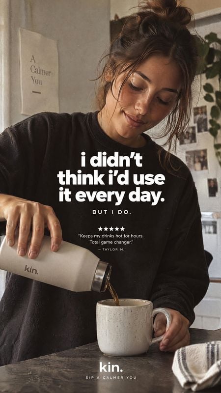 insulated drink bottle lifestyle scene product photo: A woman in a relaxed black sweatshirt pours a drink from a cream-colored Kin bottle into a ceramic mug in…
