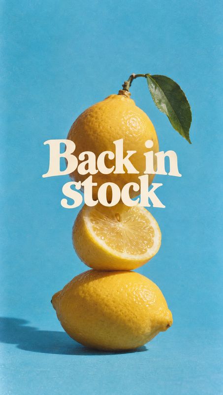 lemons ingredients product photo: A stack of bright yellow lemons, including a cut half and leafy stem, is photographed against a vivid blue studio backdrop wi…