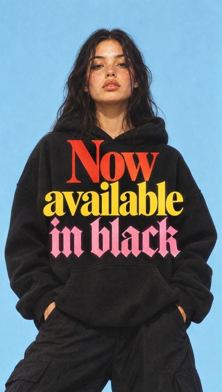 black hoodie black friday product photo: A woman models a black printed hoodie against a bright blue studio backdrop, with soft even light and bold, upbeat sty…