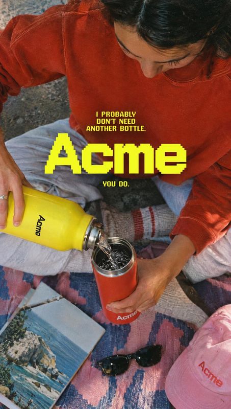 insulated bottle splash / pour product photo: An adult woman in a red sweatshirt pours from a bright yellow insulated bottle into a red cup on a patterned picn…