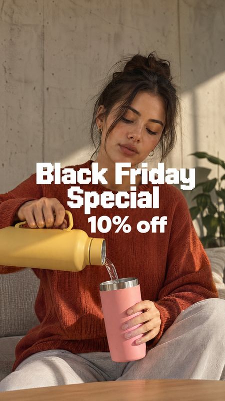 insulated bottle and tumbler splash / pour product photo: A woman in a rust-colored sweater pours from a yellow insulated bottle into a pink tumbler in a softl…