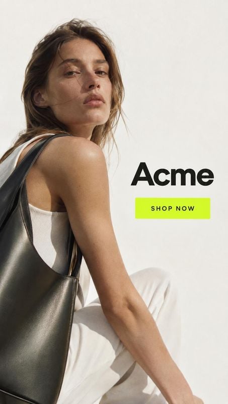leather tote bag jewelry product photo: A woman in a white outfit poses with a black leather tote against a softly lit pale studio backdrop, with bold black le…