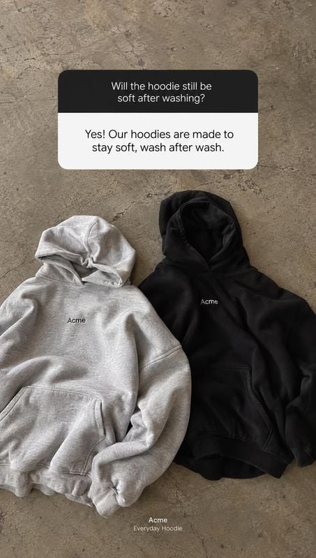 hoodies flat lay product photo: Two grey and black hoodies are arranged on a textured concrete surface beneath a question-and-answer text panel, creating a mut…