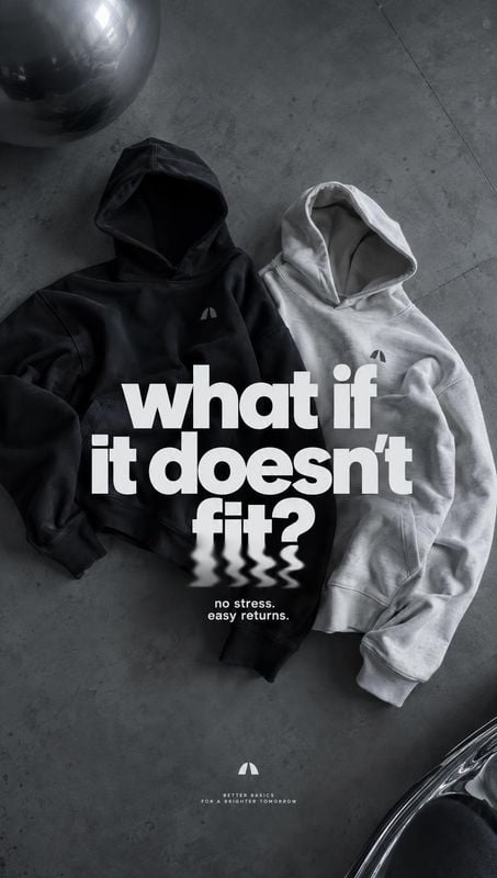 hoodies flat lay product photo: Two black and light gray hoodies are arranged on a dark concrete floor in a monochrome overhead composition, with bold white he…