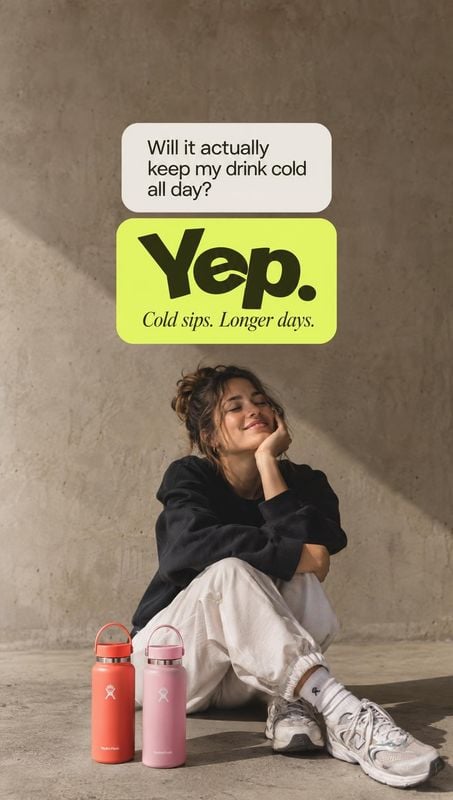 insulated water bottles lifestyle scene product photo: A woman relaxes against a warm concrete wall beside two colorful insulated bottles, while bold lime-gree…