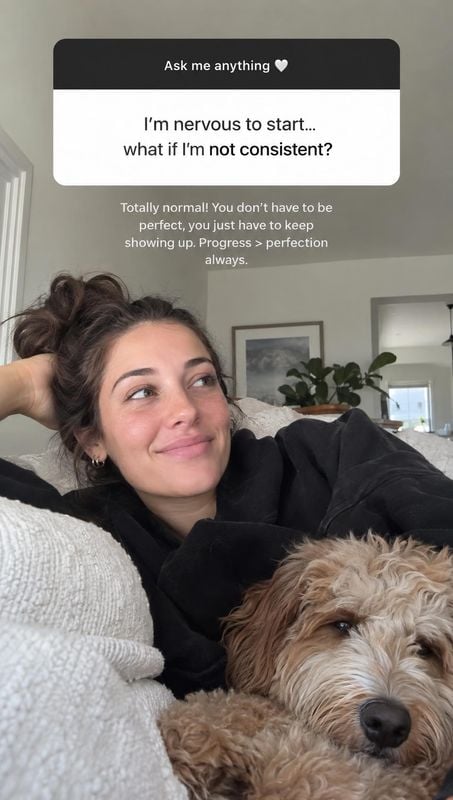 lifestyle scene product photo: A woman in a black top relaxes on a couch beside a shaggy dog in a softly lit living room, with casual Q&A text overlaid at the…