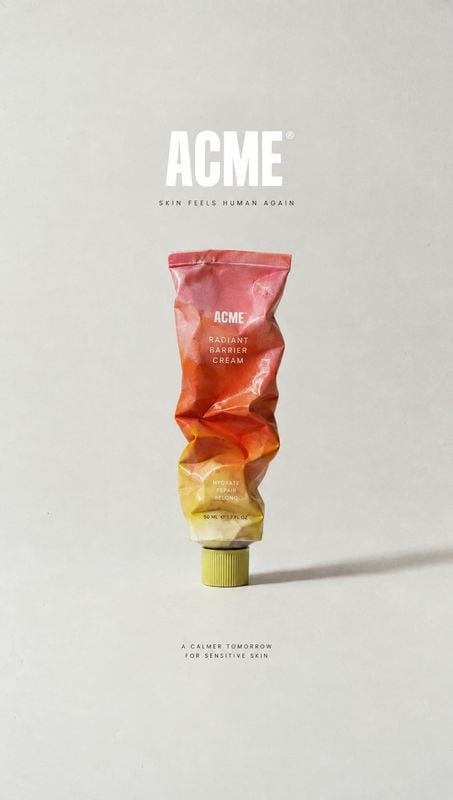 radiant barrier cream packshot product photo: A crumpled, colorful cream tube stands against a pale studio backdrop, with centered branding and fine print addi…