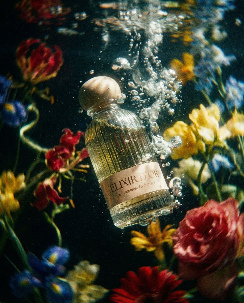 Perfume bottle submerged in an underwater floral environment with floating petals and dappled light