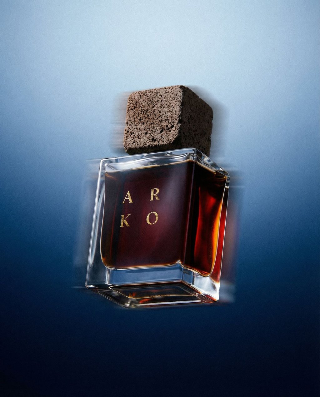 Perfume bottle floating in a Cobalt Float studio environment with diffused backlit blue tones