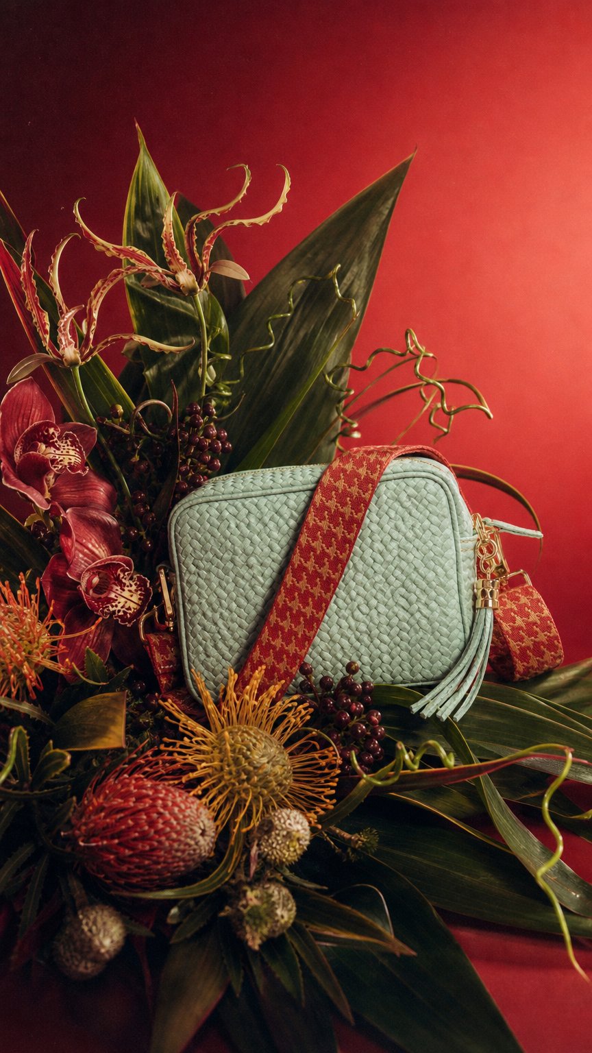 AI product shot of Woven Crossbody Aqua (Ruby Dogtooth Strap)