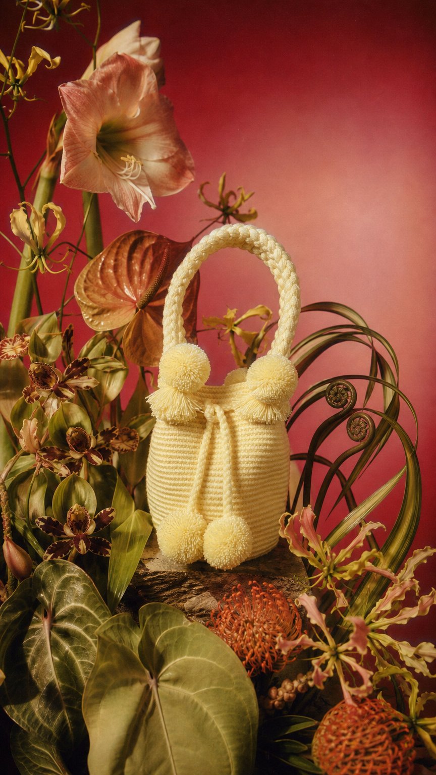 AI product shot of Butter Yellow Mini PomPom Bag
