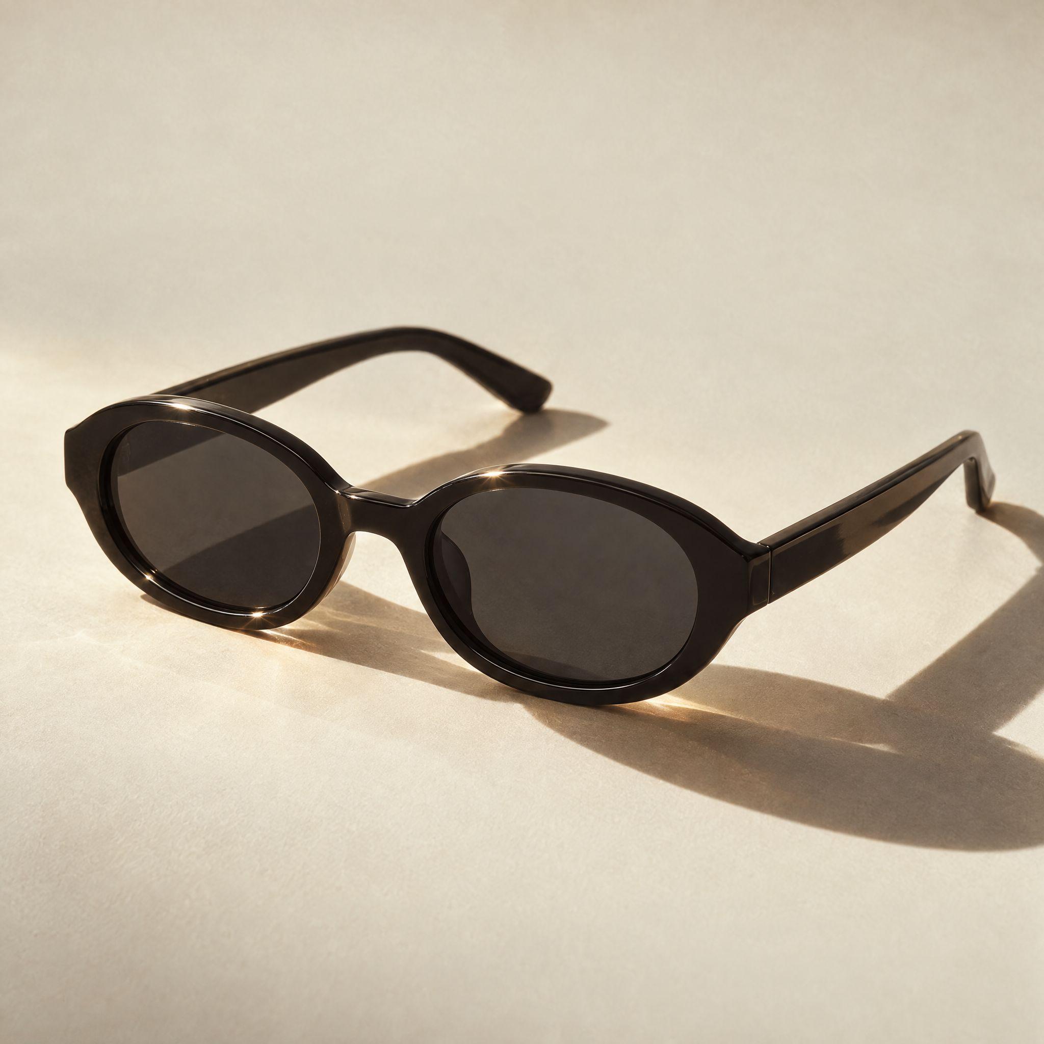 Gold diamond ring and black oval sunglasses, each shot in the same low warm sunlight with long shadows - After