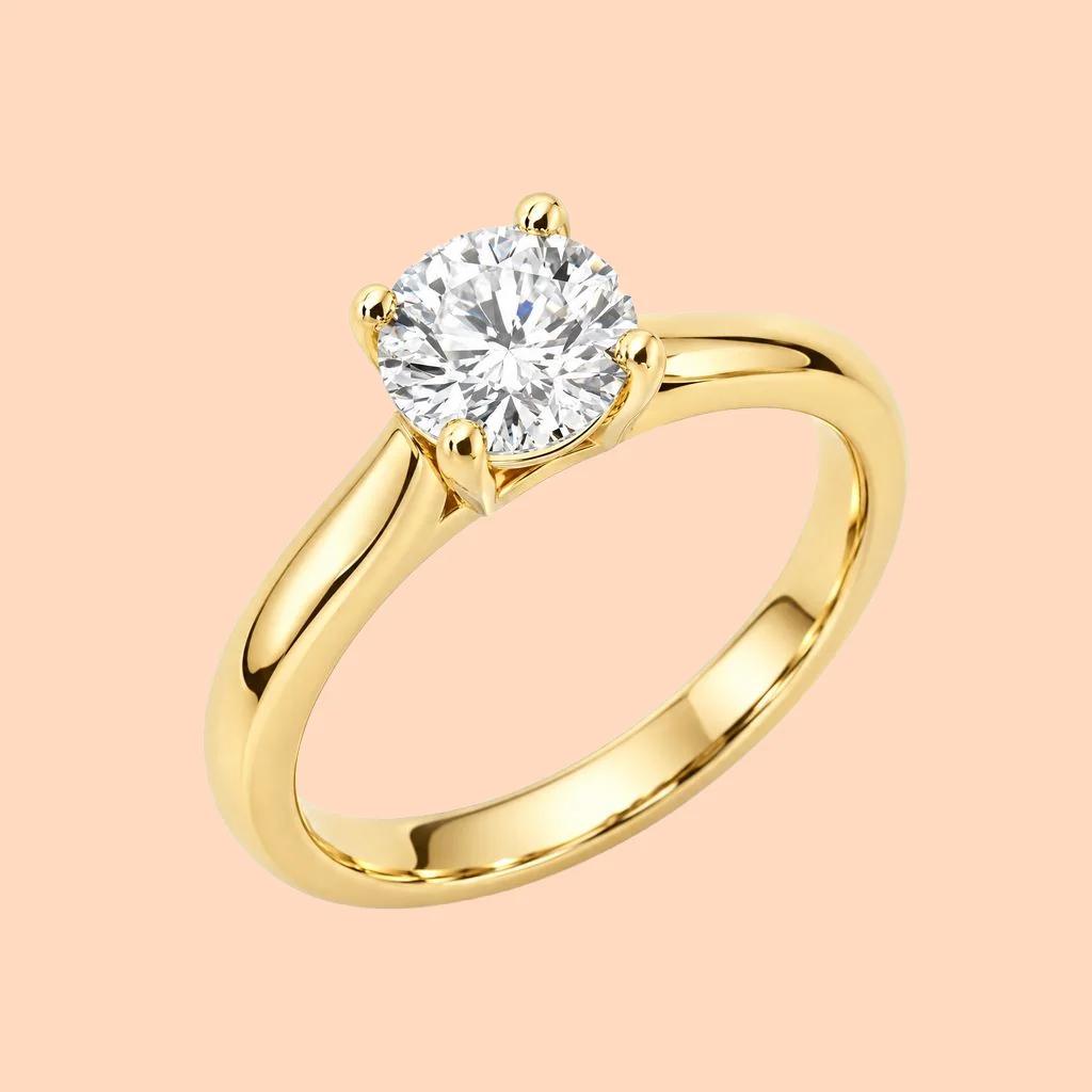 Gold solitaire diamond ring on a white background, and the same ring on a flat peach background - After