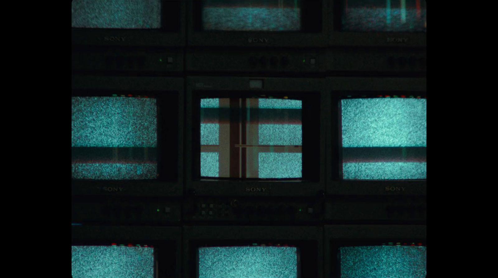 a bunch of televisions that are sitting in a room