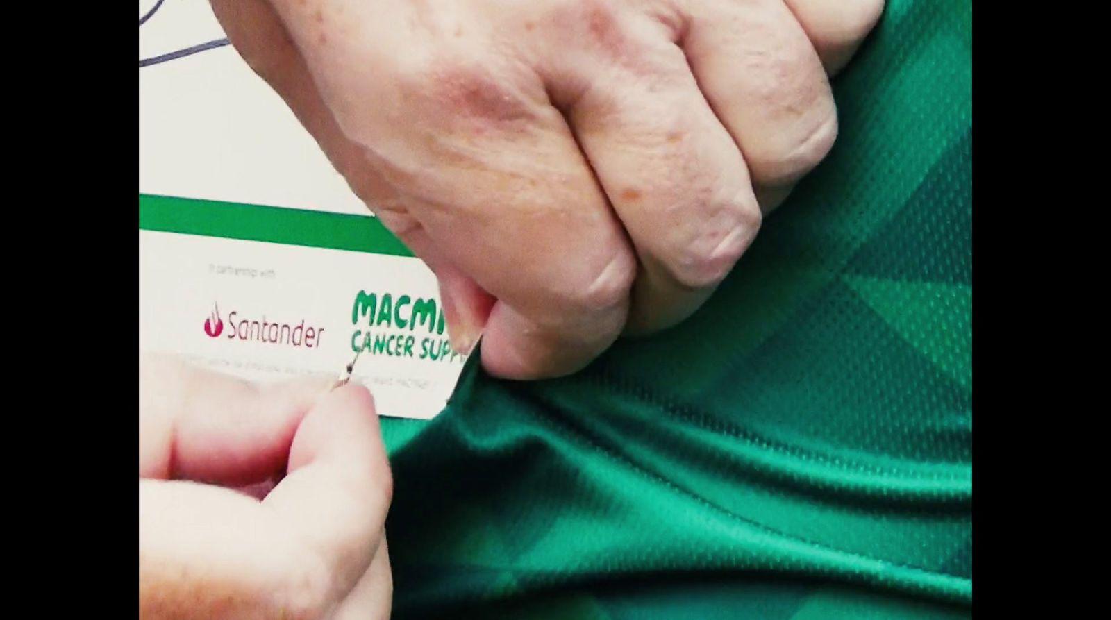 a person is holding onto a green shirt