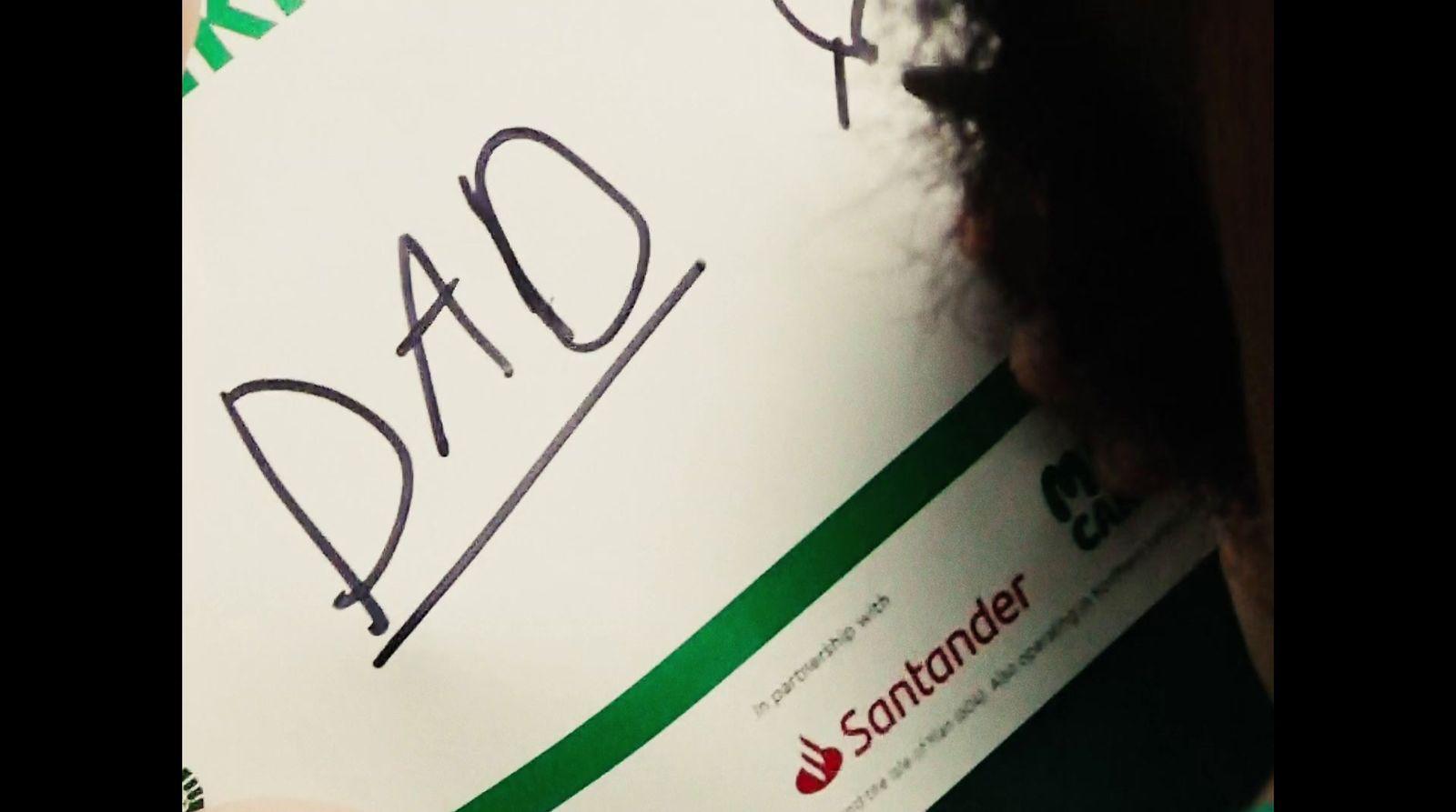 a close up of a person holding a sign with writing on it