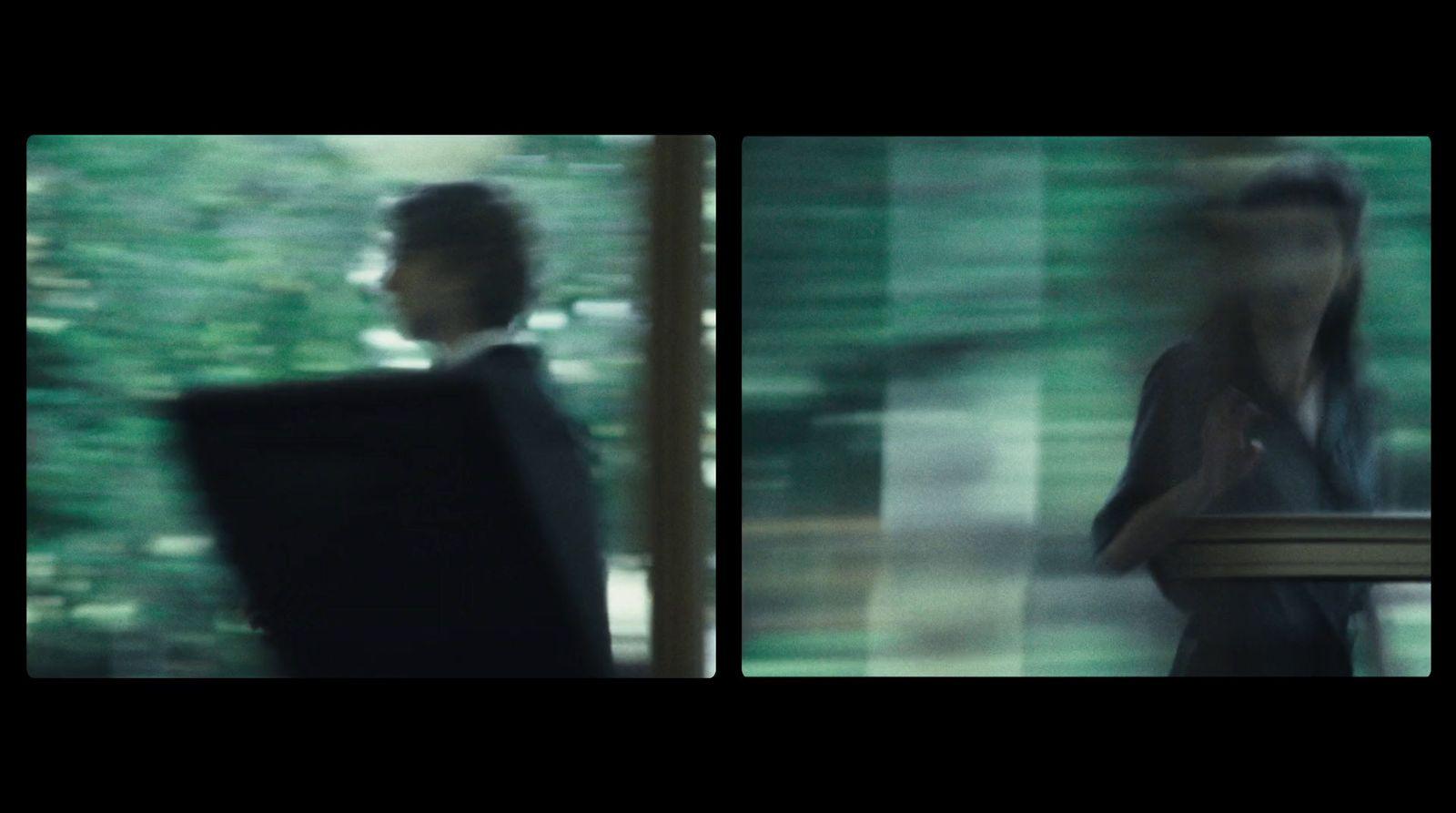 a blurry photo of a man standing in front of a window