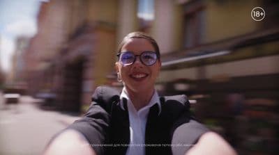 a woman wearing glasses taking a selfie