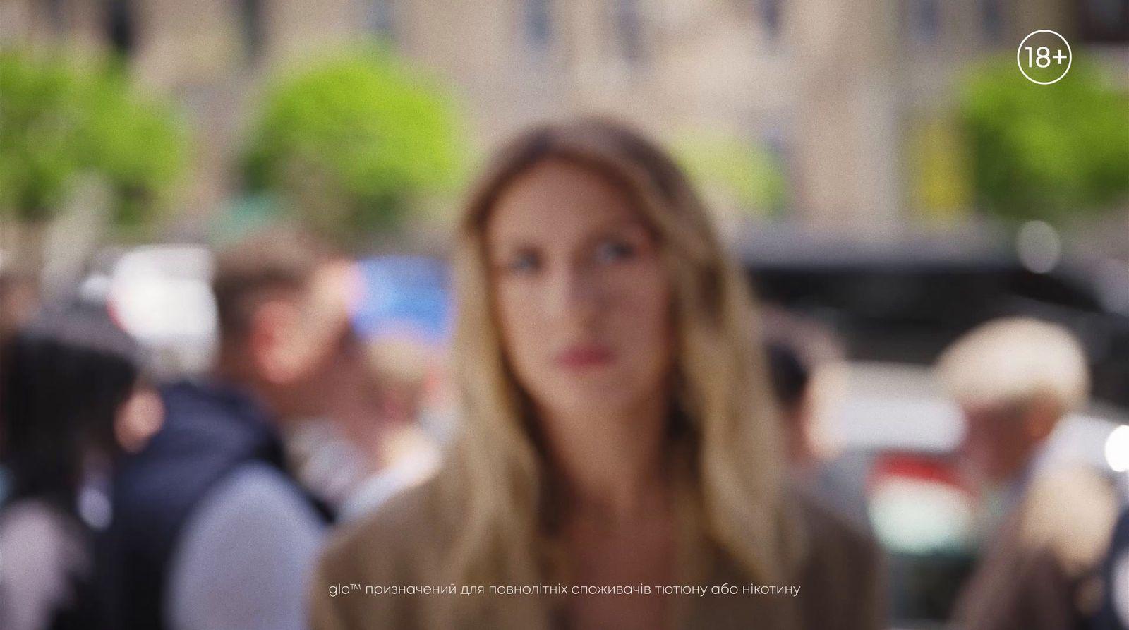 a woman standing in front of a crowd of people