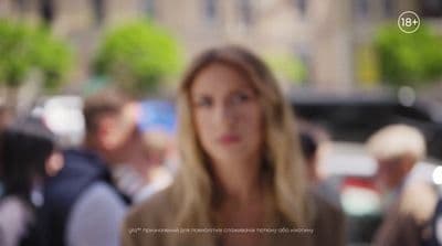 a woman standing in front of a crowd of people