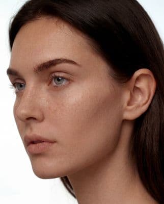 a close up of a woman with freckles on her face
