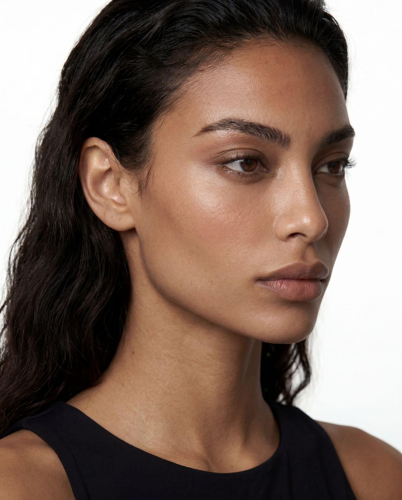 a close up of a woman wearing a black top