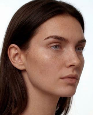 a close up of a woman with freckles on her face