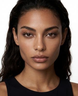 a close up of a woman wearing a black top