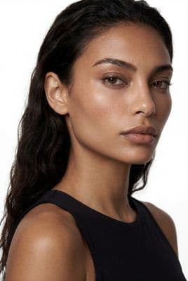 a close up of a woman wearing a black top