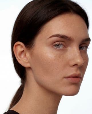 a close up of a woman with freckles on her face