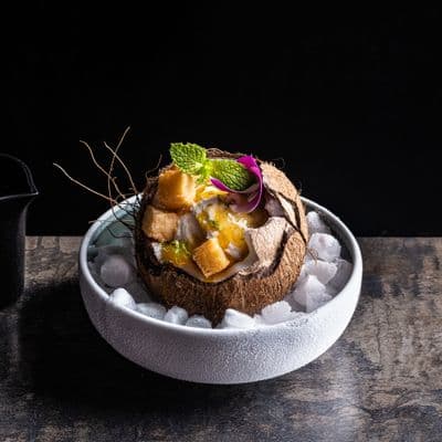 a bowl of food on a wooden table
