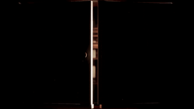 a woman standing in front of a black background