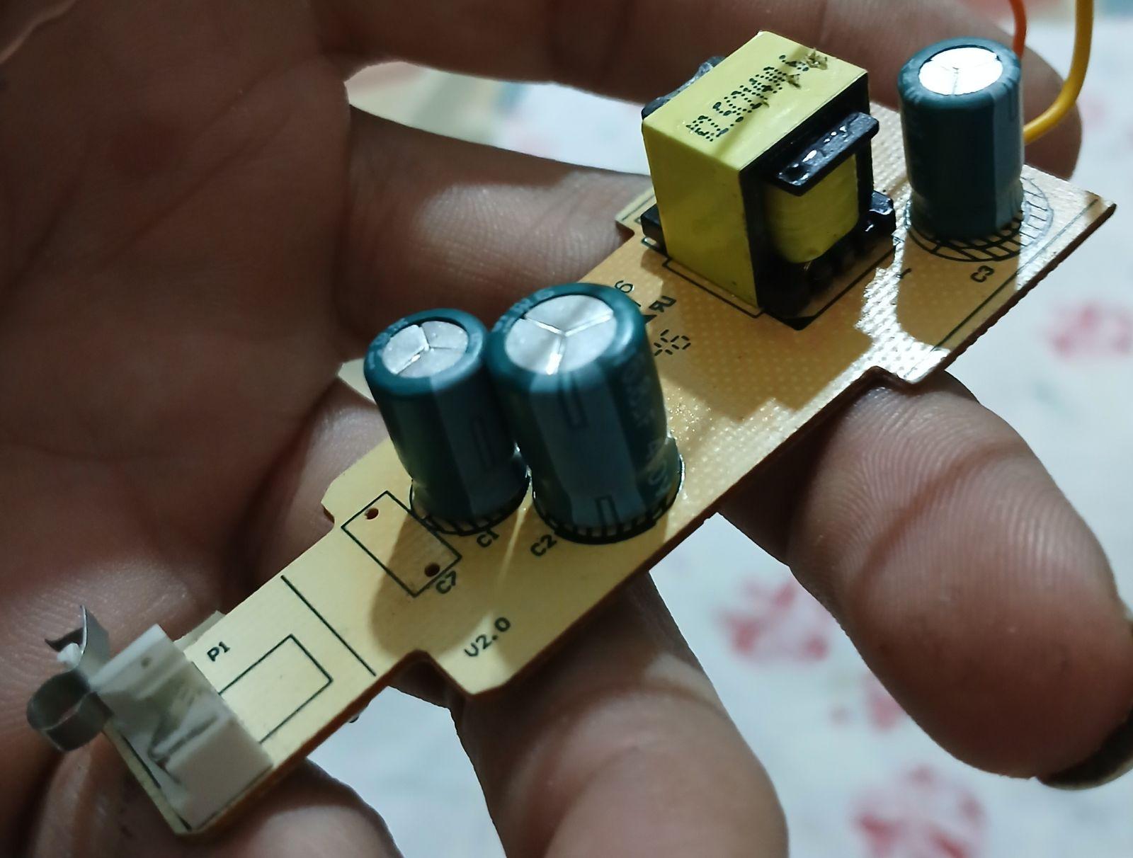 a person holding a small electronic device in their hand