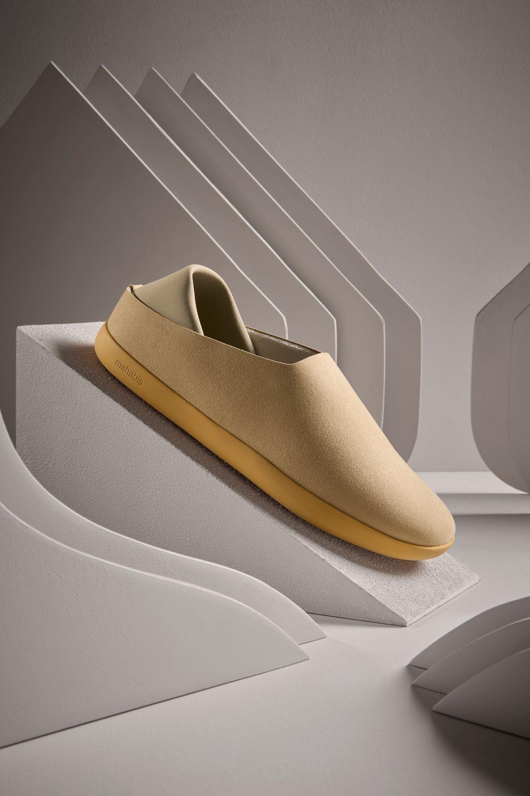 a pair of shoes sitting on top of a white surface
