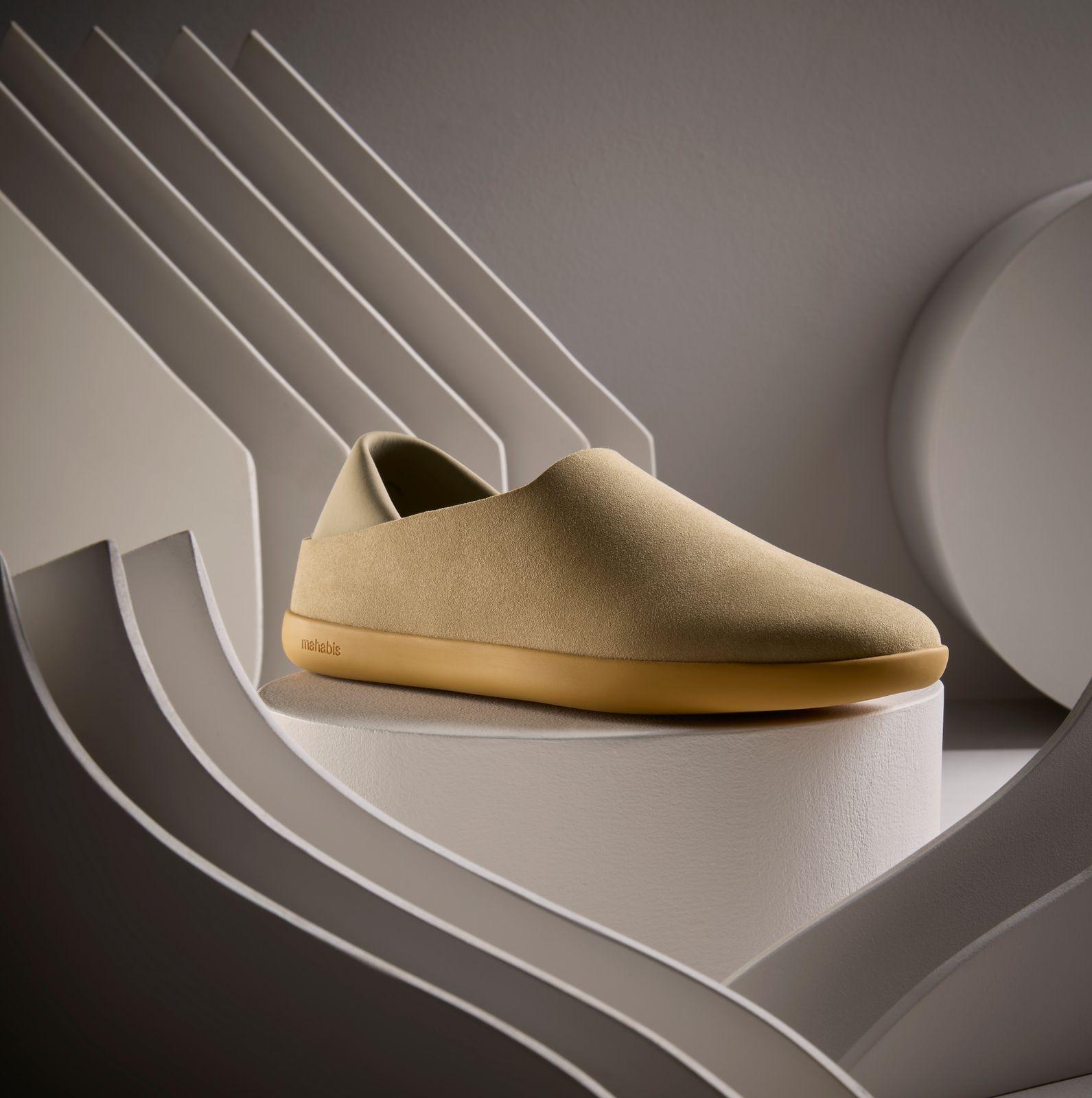 a pair of shoes sitting on top of a white shelf