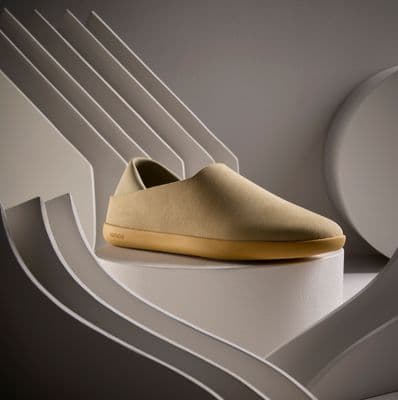 a pair of shoes sitting on top of a white shelf