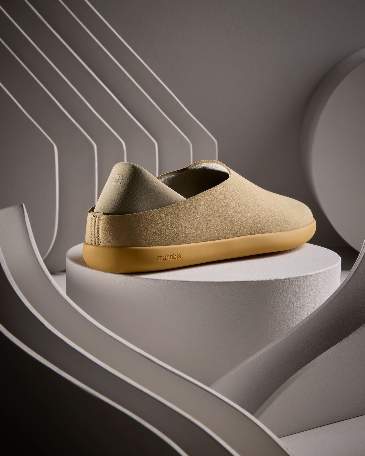 a pair of shoes sitting on top of a white pedestal
