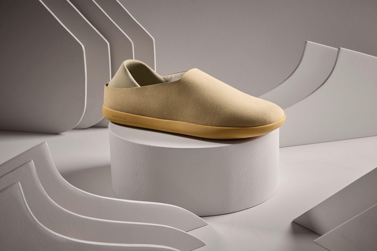 a pair of shoes sitting on top of a white pedestal