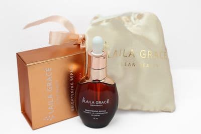 a bottle of perfume sitting next to a bag