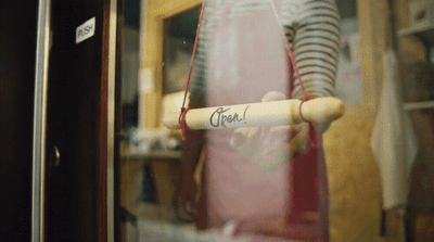 a mannequin holding a baseball bat in a store window