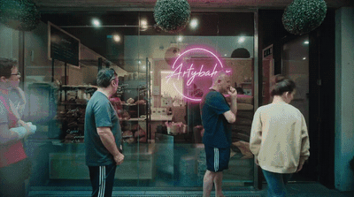 a group of people standing in front of a store