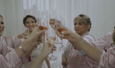 a group of bridesmaids toasting with champagne