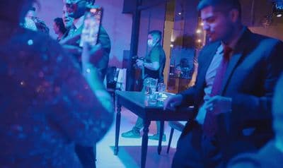 a group of people standing around a table
