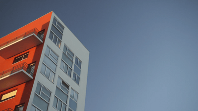 a tall building with balconies on the top of it