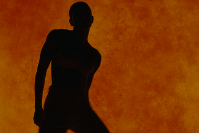 a silhouette of a woman standing in front of a wall