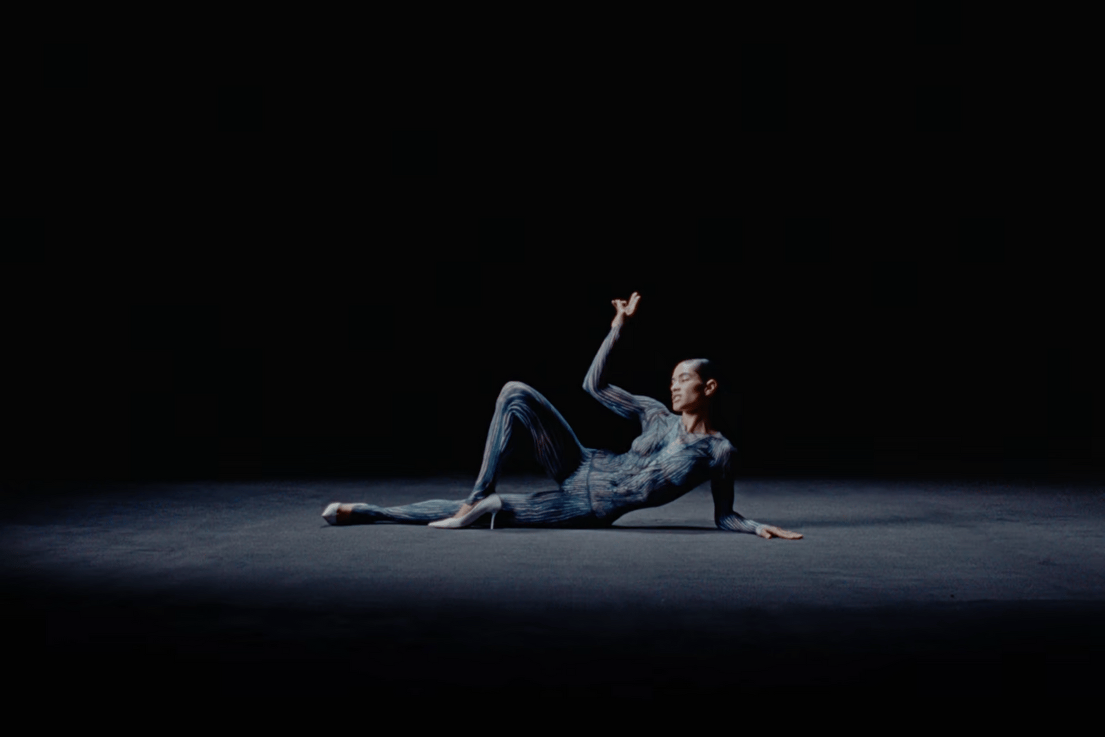a man laying on the ground in the dark