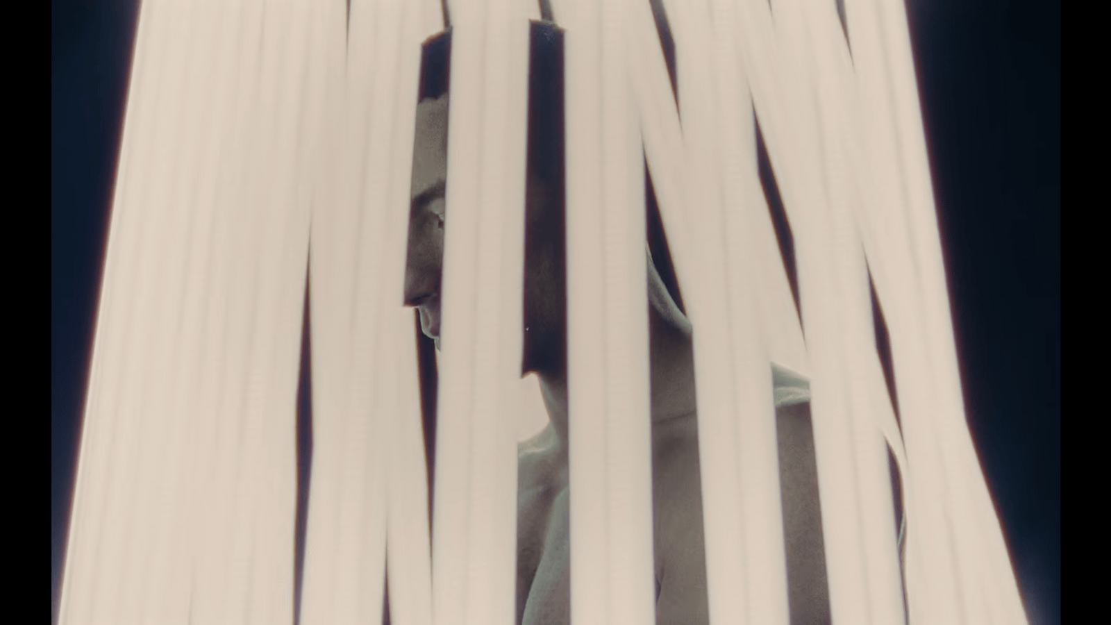 a man is peeking through a white curtain