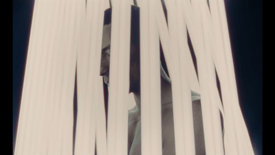 a man is peeking through a white curtain