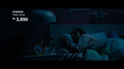 a woman laying in bed in a dark room